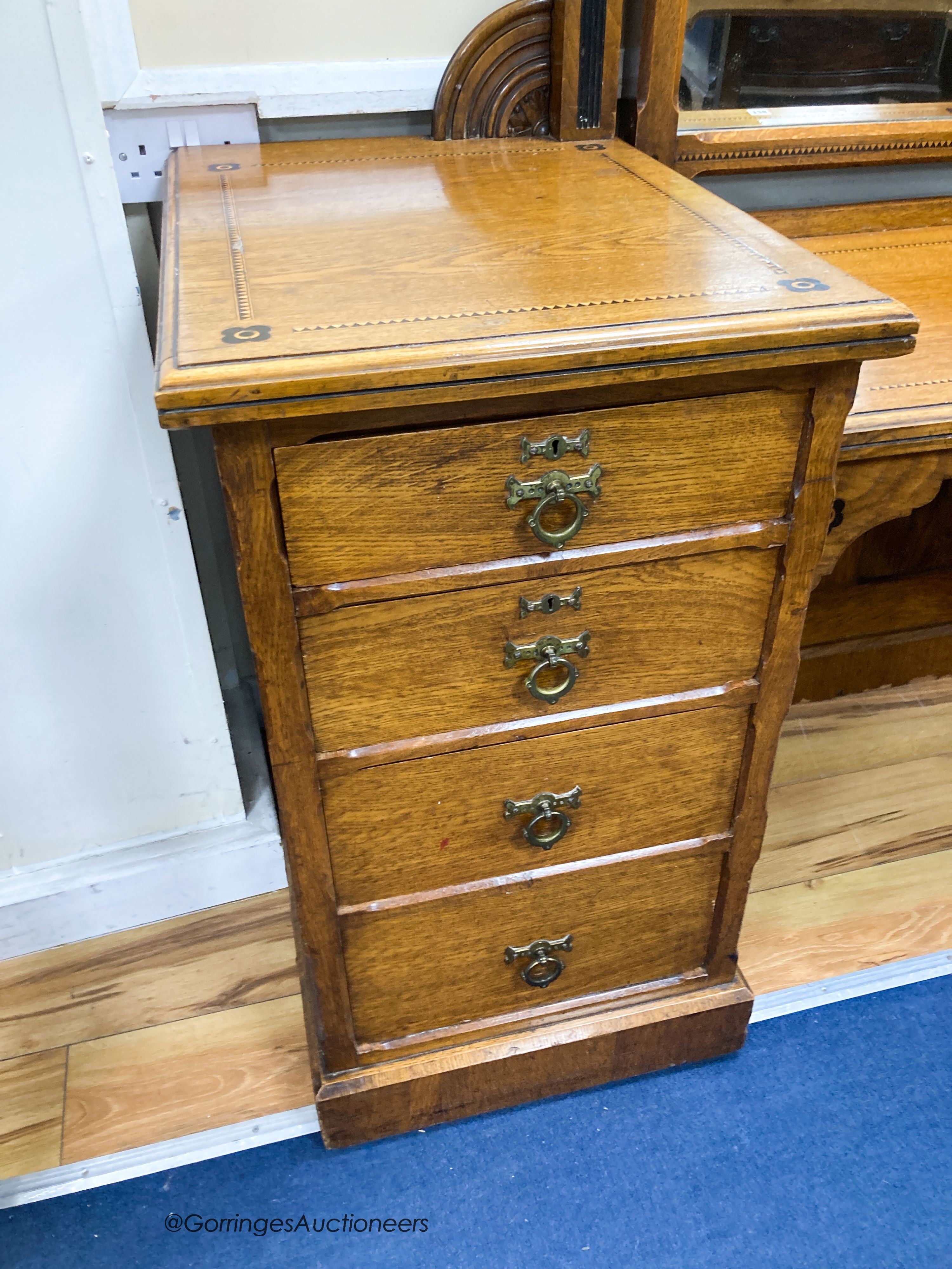 A late Victorian inlaid oak Aesthetic movement dressing table by Garnett & Son, Warrington, width 161cm, depth 59cm, height 176cm